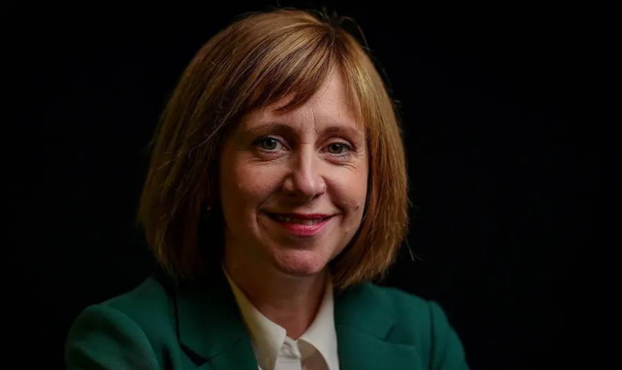 Head and shoulder portrait of Roisha Hughes with dark background