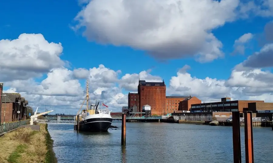 a large ship docked on the river in Grimsby