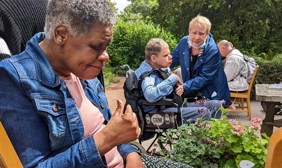 Adults with complex care needs in a garden
