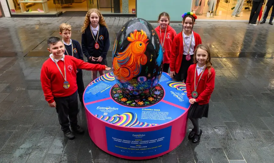 Children stand next to pysanka egg display for Eurovision celebrations