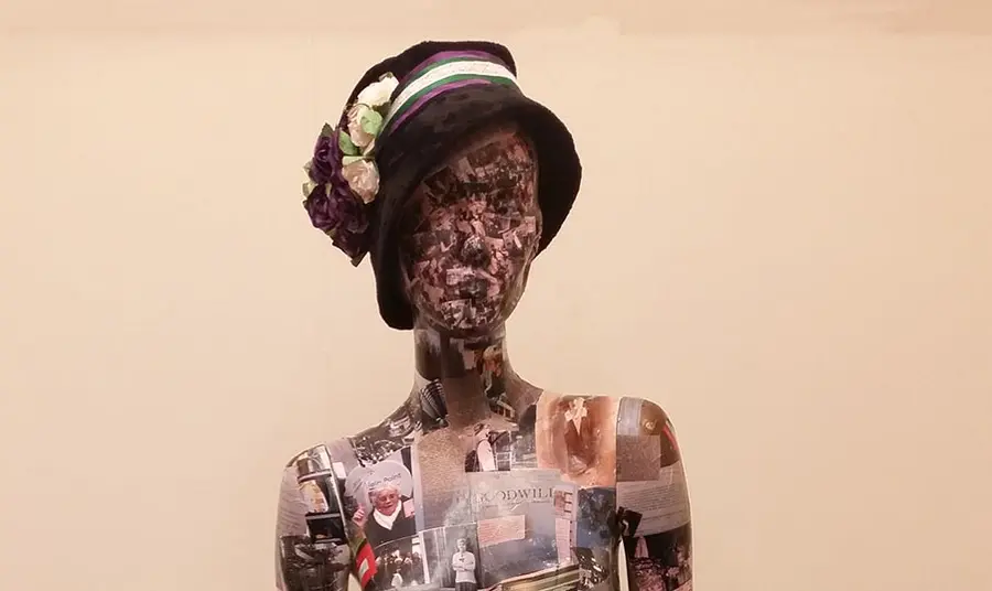 A mannequin covered in photos and documents. Volunteers created the 'Wo-Mannequin' from photos of the research, visits and materials they collected during the project