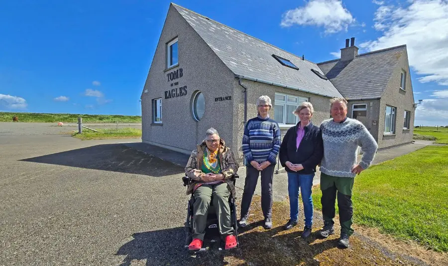 srbdt-office-bearers-and-owners-tomb-of-the-eagles.jpg Four members of the Trust stand outside the Tomb of the Eagles visitor centre.