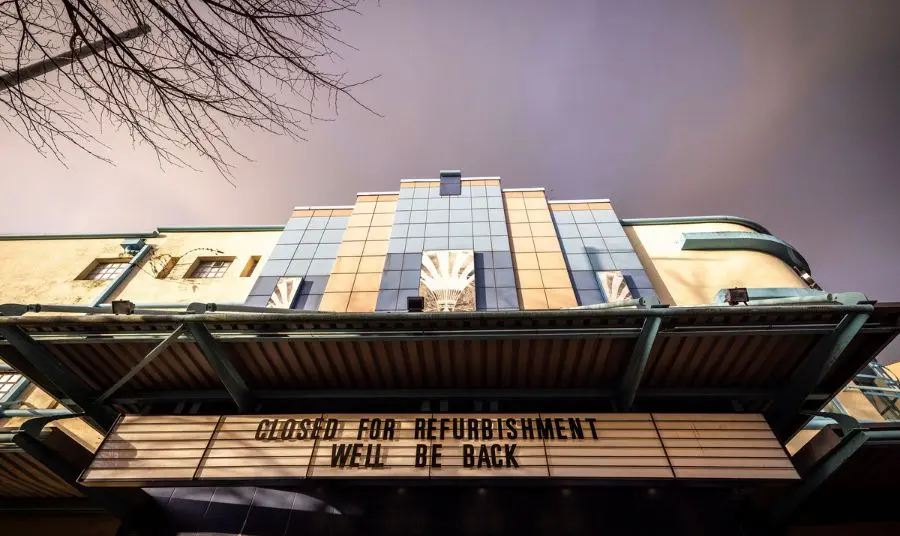 The art deco facade of the Strand Arts Centre with cinema lettering reading 'Closed for refurbishment. We'll be back"