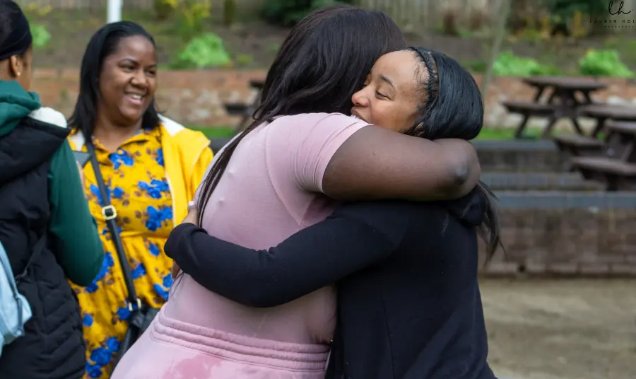RoseTinted Financial workshop Photograph of two women hugging each other in a park