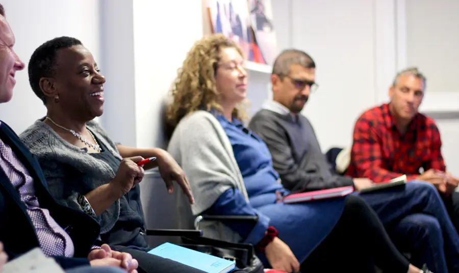 A group of people taking notes in a workshop