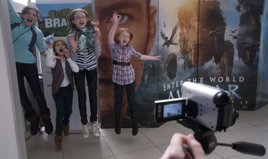 Children jump in front of a video camera
