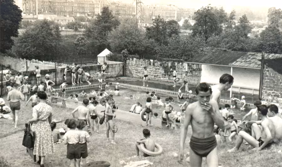 A black and white image of people Cleveland Pools on a busy day with lots of people in the water and around the pool.