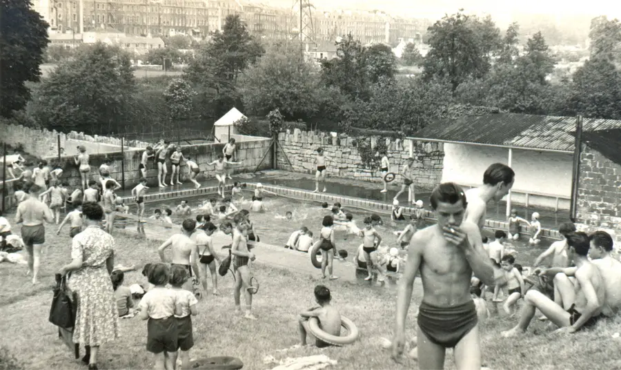 A black and white image of people Cleveland Pools on a busy day with lots of people in the water and around the pool.