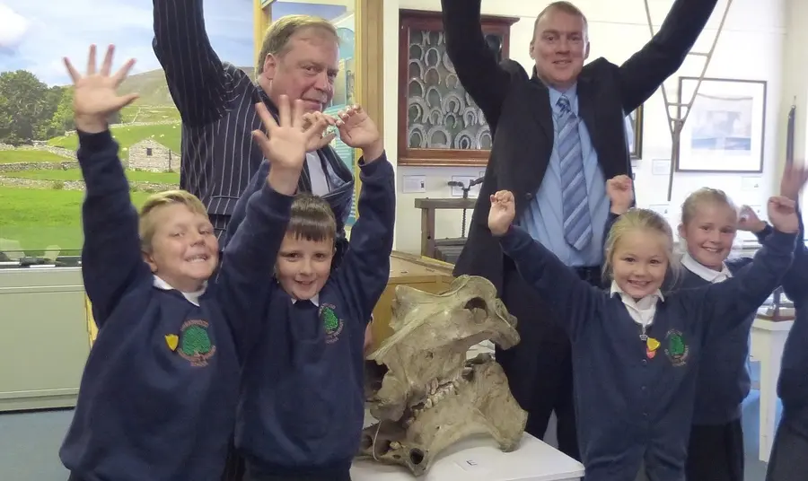 Pupils from Greatwood Primary School, Cllr Simon Myers and Paul Ellis (Director of Services) celebrate Craven Museum and Gallery first round pass