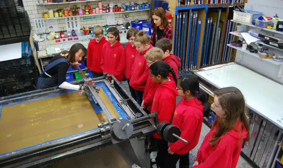 Primary schoolchildren being demonstrated the art of printmaking