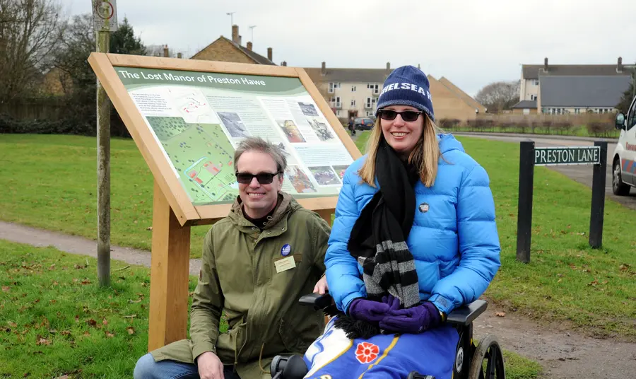 Changing lives: Antoinette and Wayne really dig their new-found interest Volunteers Wayne and Antoinette by an information board