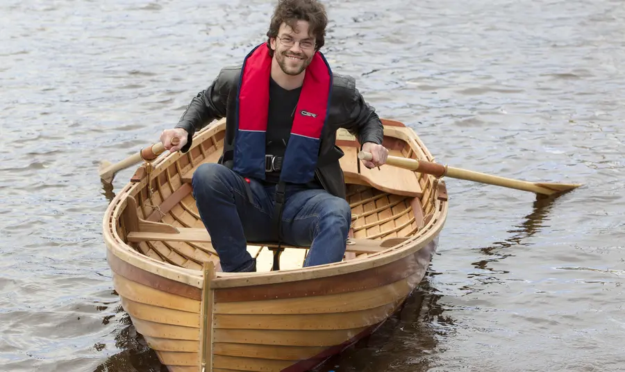 A man in a dinghy on the River Clyde