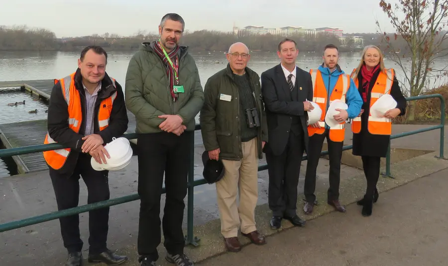 People stand in front of river