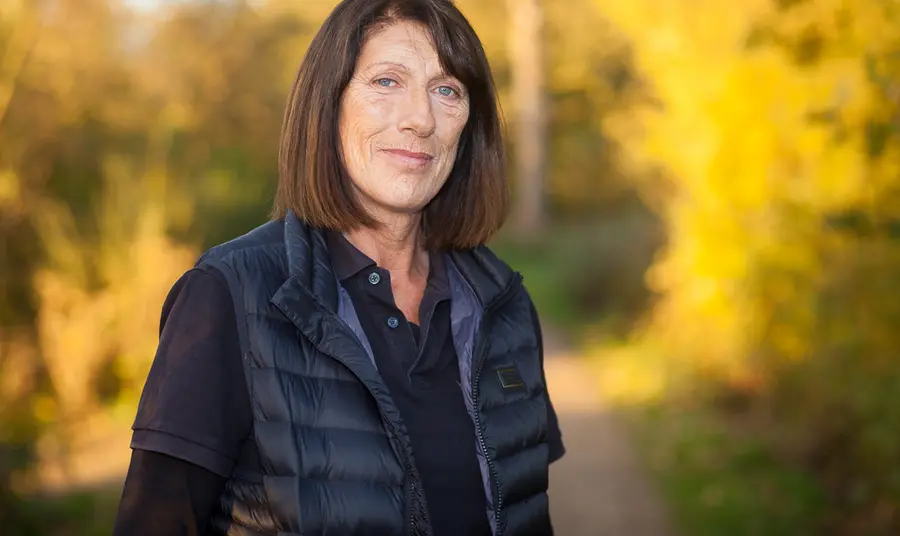 Changing lives: from hostage rescue to nature reserve A woman stands in front of autumn trees