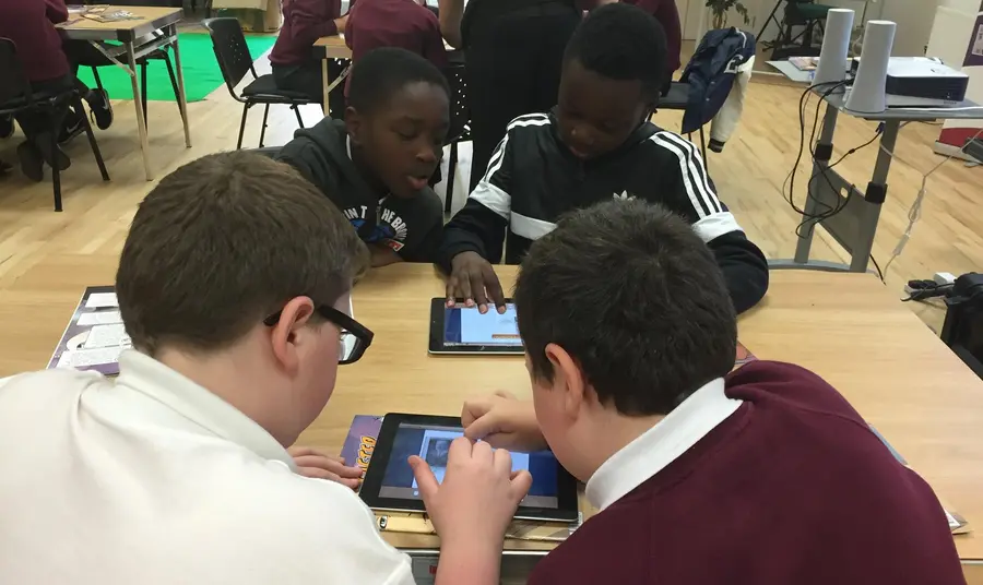 Young participants looking at iPads