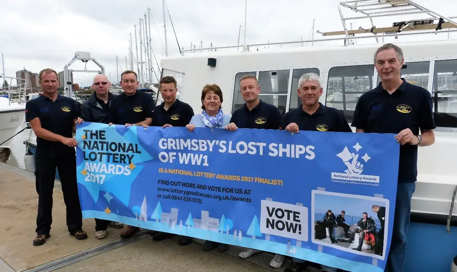 Linda Wood (centre), descendant of the captain of sunken trawler, Alberta, with the dive team