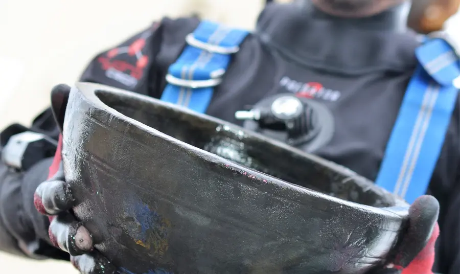 Senior archeaologist Giles Richardson with a bowl retrieved from HMS Invincible