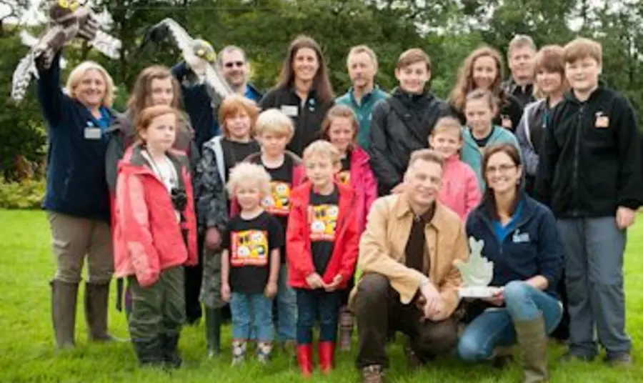 Wildlife broadcaster Chris Packham (centre) joins volunteers and staff from the RSPB to celebrate National Lottery Award win