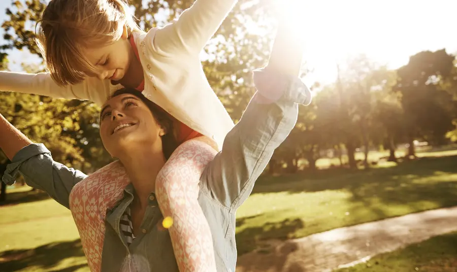 A mother and child have fun in a park