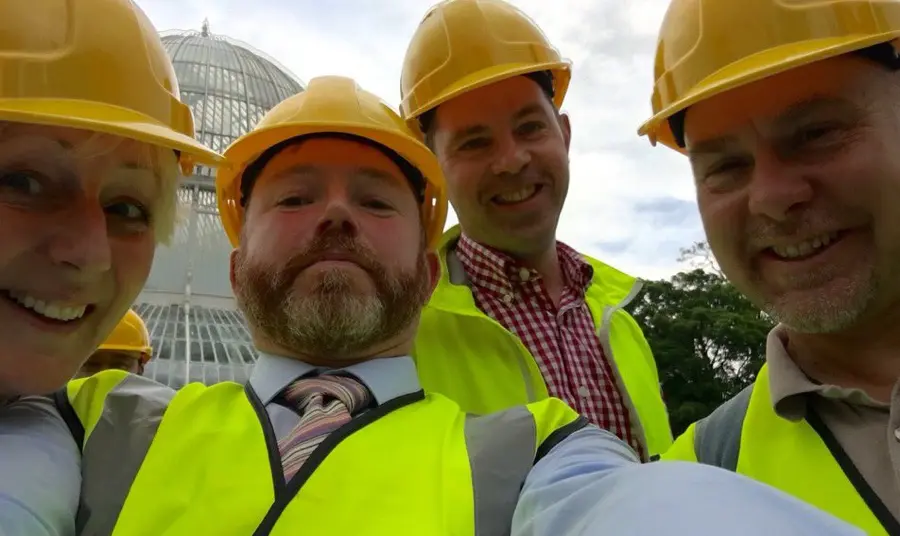 People in hard hats take a selfie 