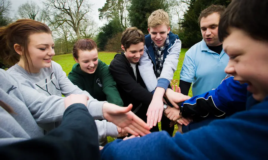 Young people teambuilding in a park