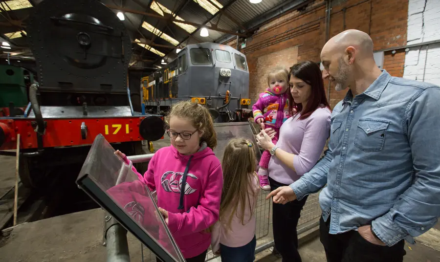 A family enjoys one of the exhibits at the Railway Museum