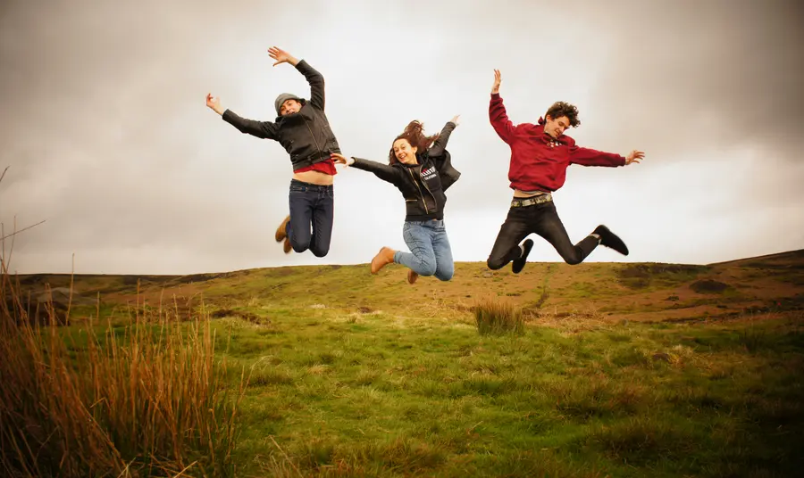 Young people jumping in a field