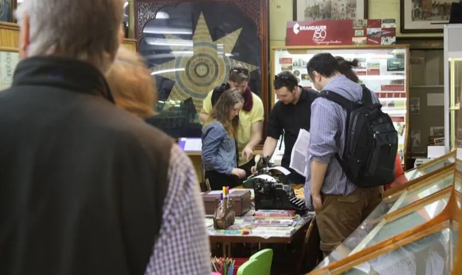 'Write Here, Write Now', Birmingham Visitors observing a typewriter on display at the museum