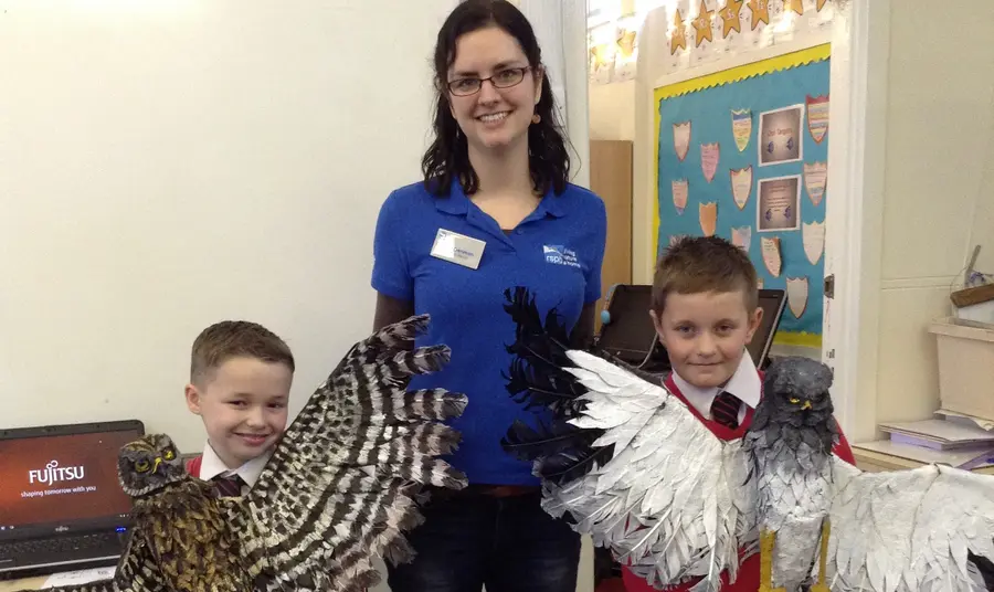 School children holding hen harrier models