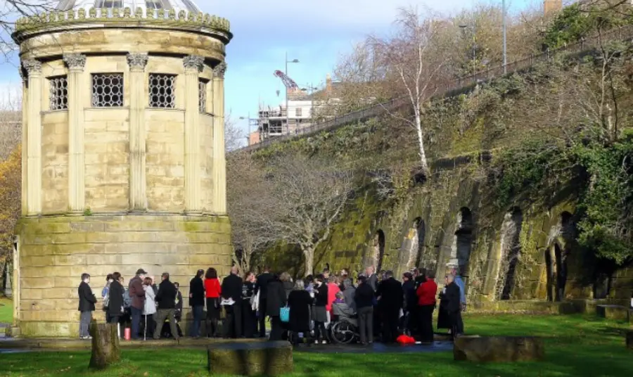 A group of people gathered in a graveyard