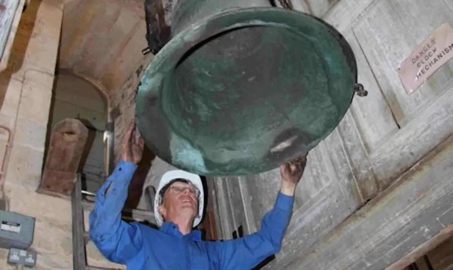 A volunteer restoring one of the bells at St Rumbald’s, Stoke Doyle 