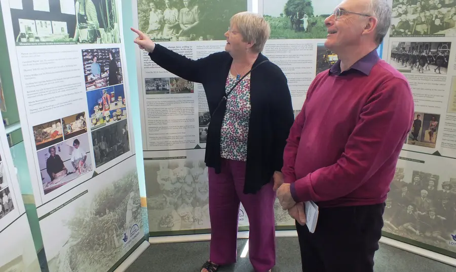 Two people look at the travelling exhibition at Ely Library