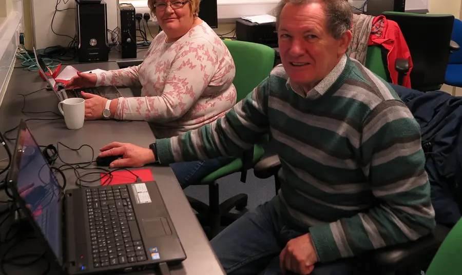 Man and a woman using computers