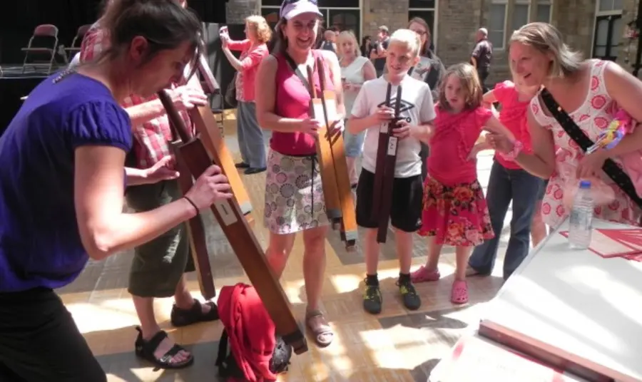 Children learning about a pipe organ in a workshop