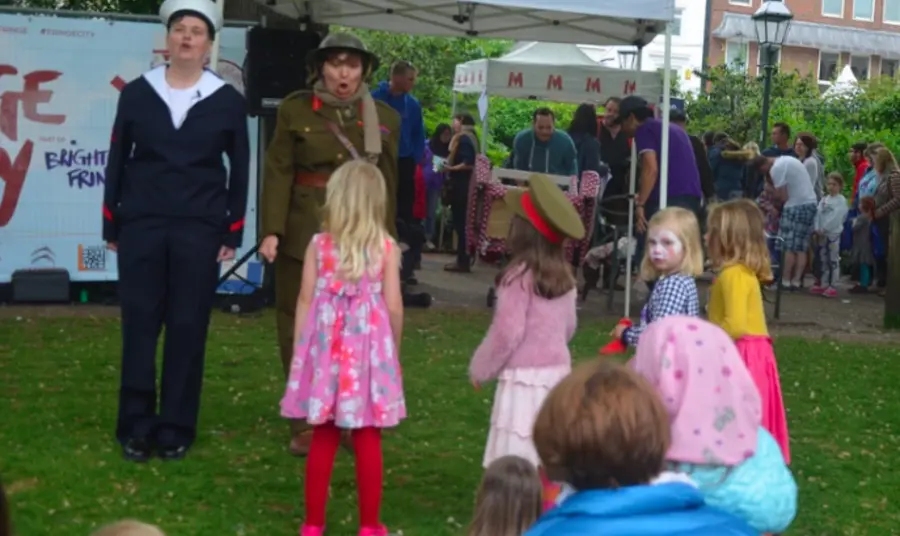 Two women dressed in male first world war uniform at family event