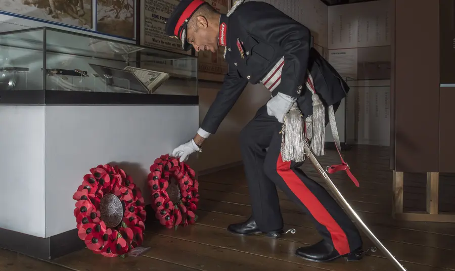 Veteran laying wreath of poppies at the celebration event