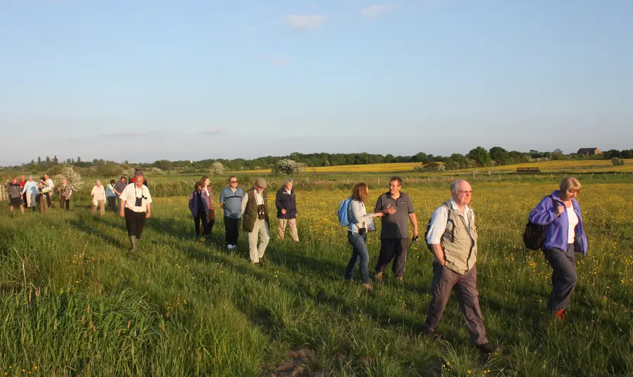 People walk across Lightshaw Meadows