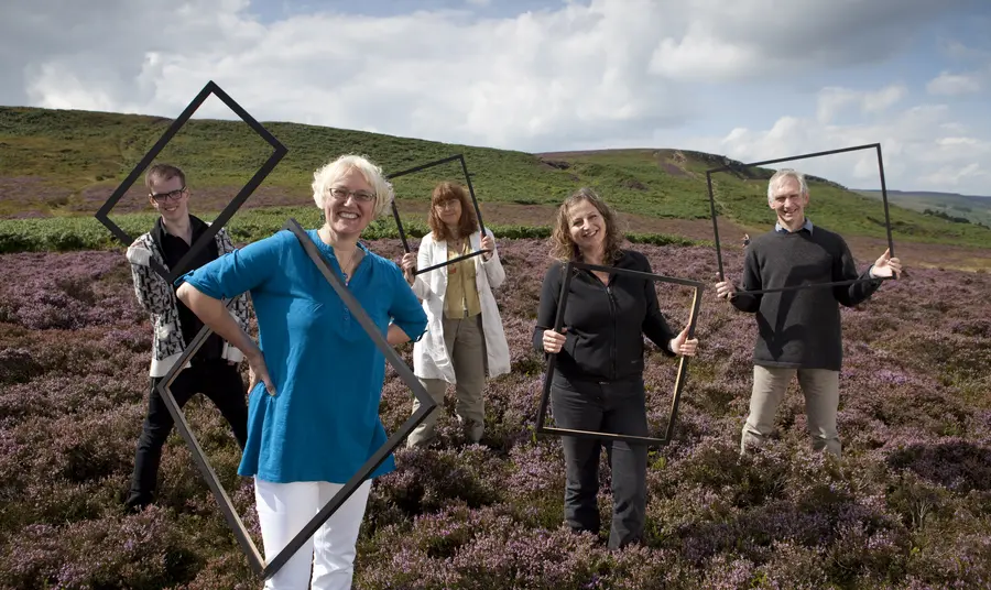People holding up frames on the Watershed Landscape People holding up frames on the Watershed Landscape