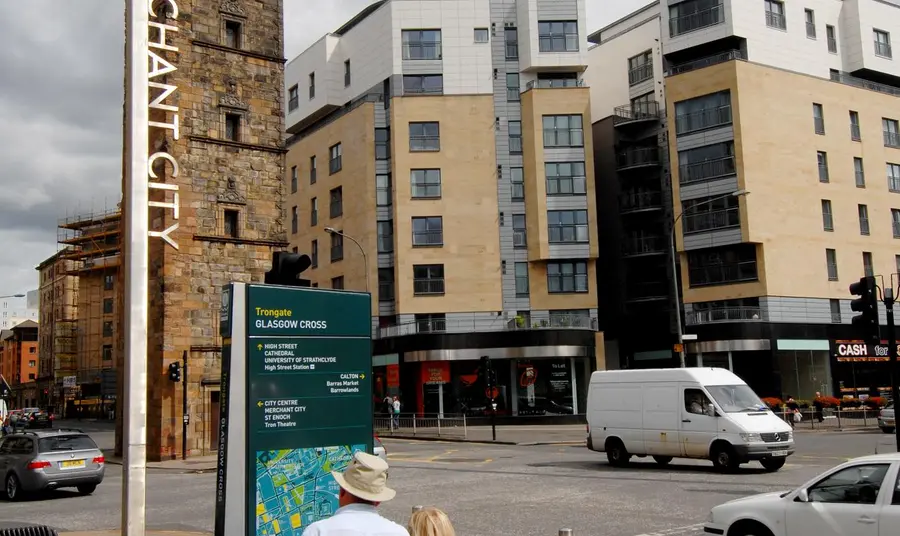 A couple read an information board in Merchant City