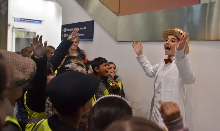 Young actor playing the part of an ice cream seller for visiting school pupils