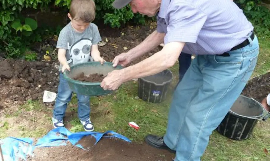 A child being shown the basics of archaeology