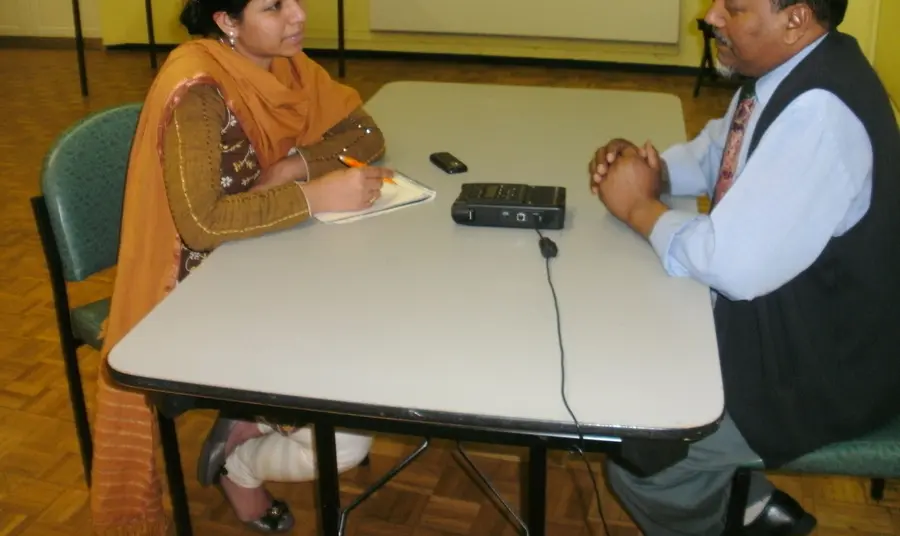 Adult volunteers conduct oral history interviews