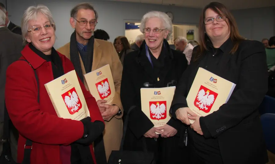 A group hold up books as part of the Poles in the Bristol Area project