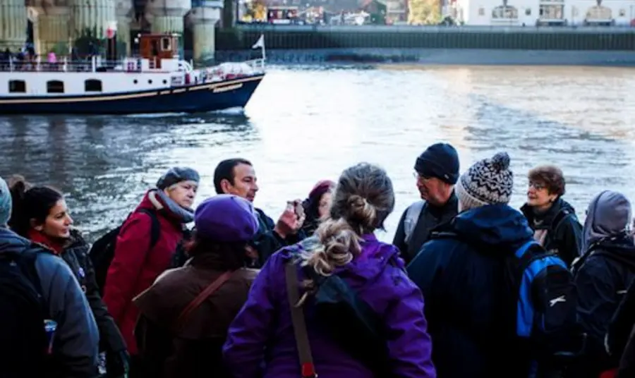 An expert explaining the historical significance of the docks, on site