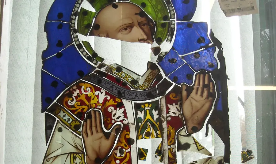 Broken pieces of stained glass window depicting St Ignatius Loyola 
