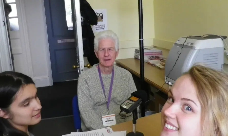 Two students interviewing an older person