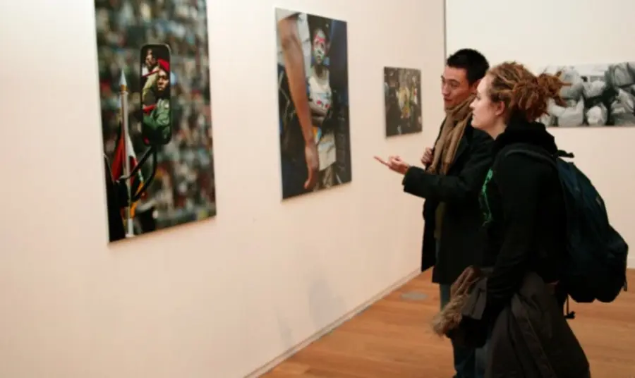 People look at pictures in Manchester Art Gallery 