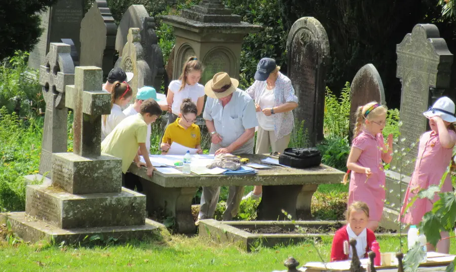 Workshop where children are doing rubbings on grave stones