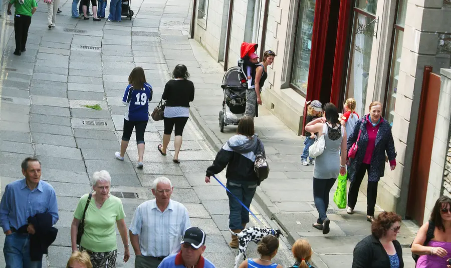 Visitors and shoppers on a street in Stromness
