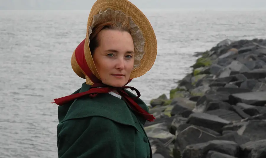 An actor in traditional dress standing on the Jurassic Coast